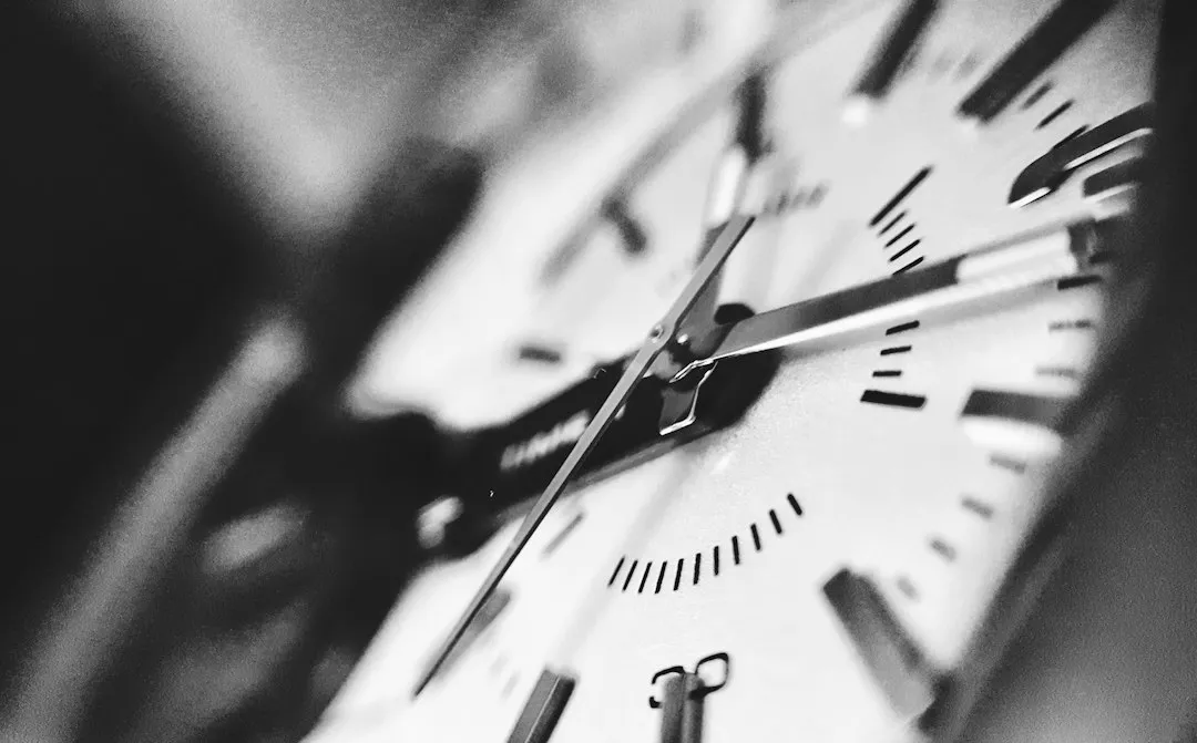 Close-up of a watch face showing the hour, minute, and second hands.
