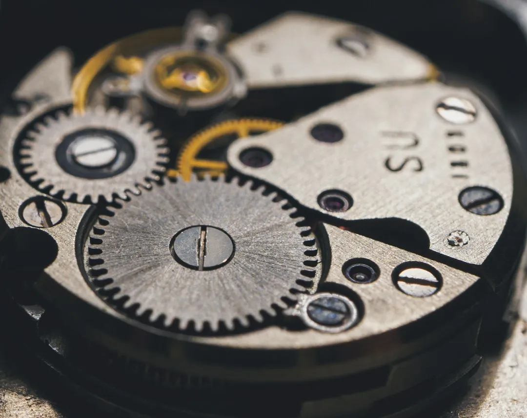 A close-up view of the intricate gears and bridges inside a mechanical watch movement.