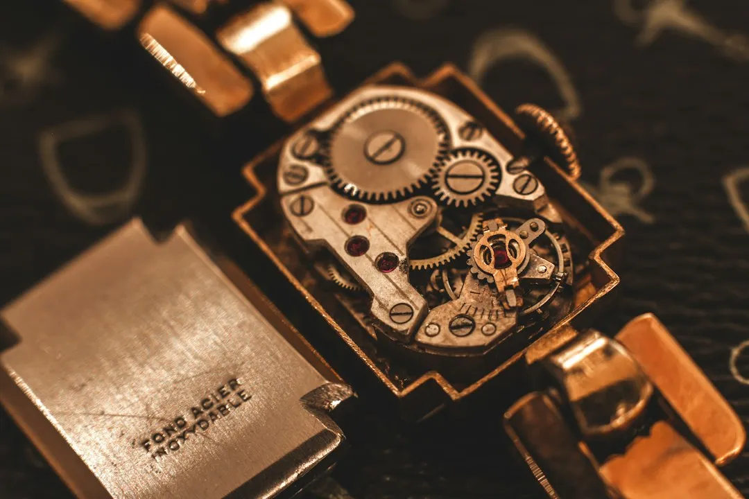 A close-up of a vintage Longines wristwatch movement with the case back removed.